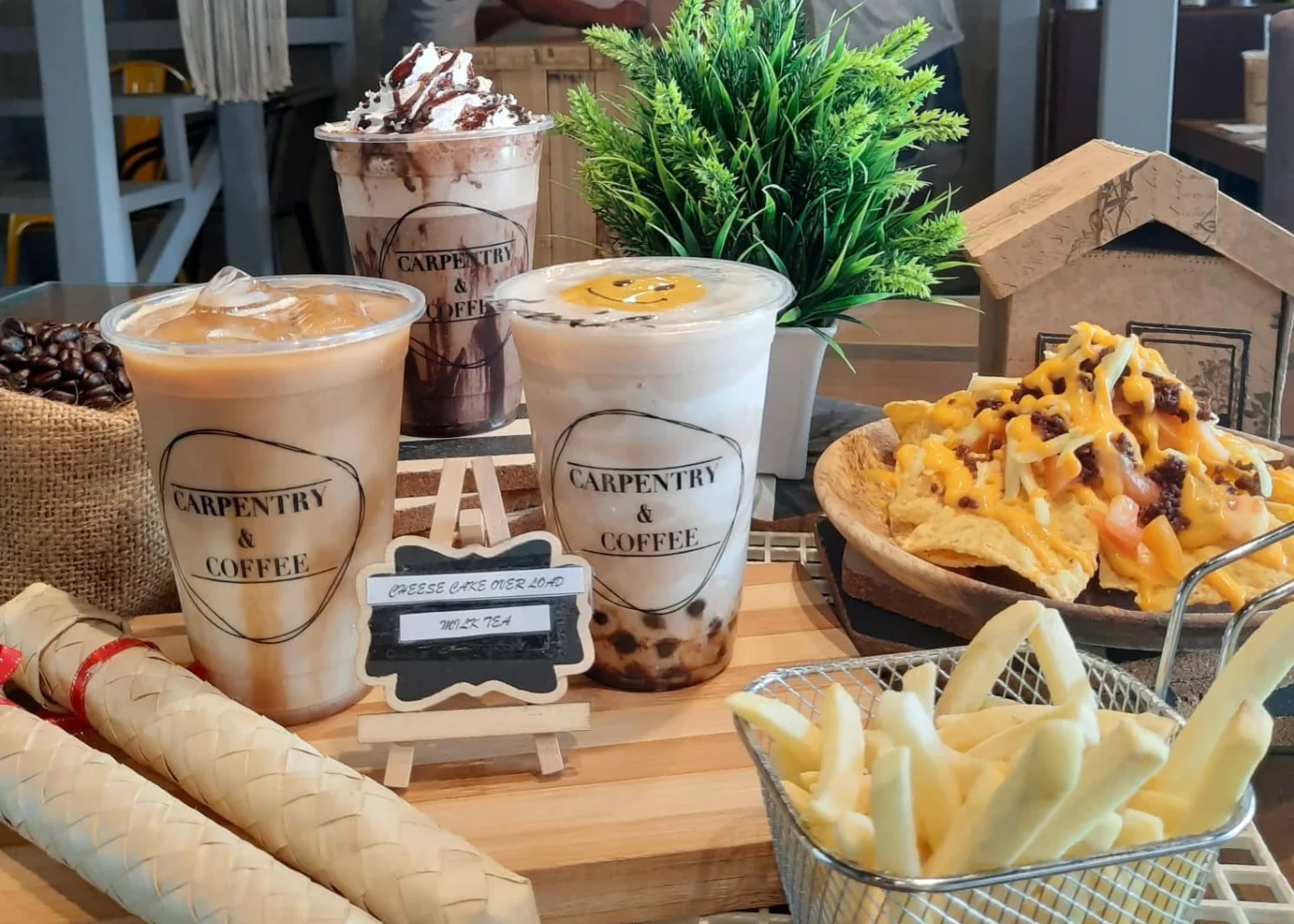 Iced drinks, nachos, and fries on a table at Carpentry and Coffee.